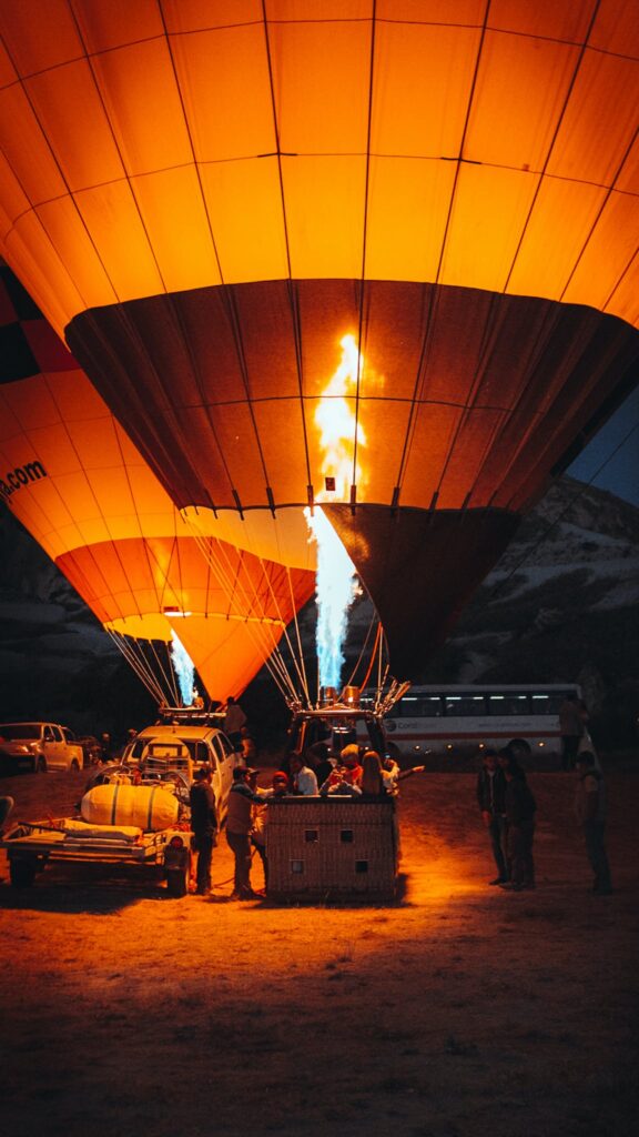 People Standing Near Hot Air Balloon during Night Time