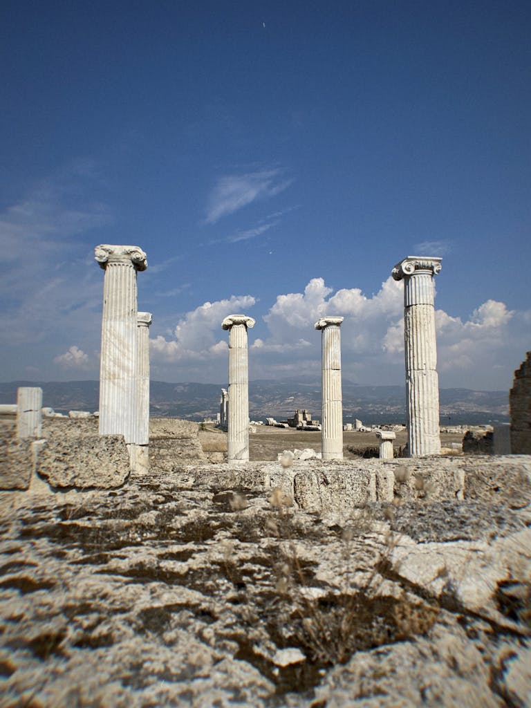 The ruins of a temple with columns and a blue sky